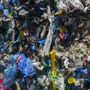 Close-up of compacted plastic waste ready for recycling, highlighting environmental issues.